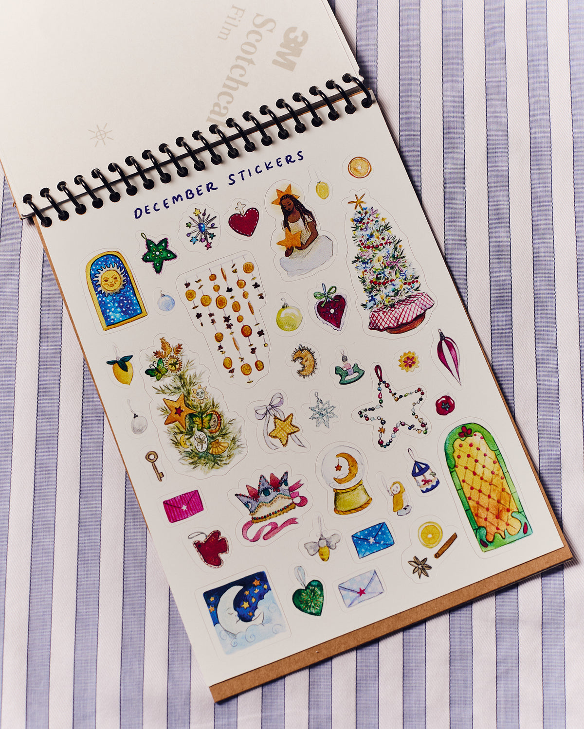 Sheet of December themed tickers with various designs on a striped background