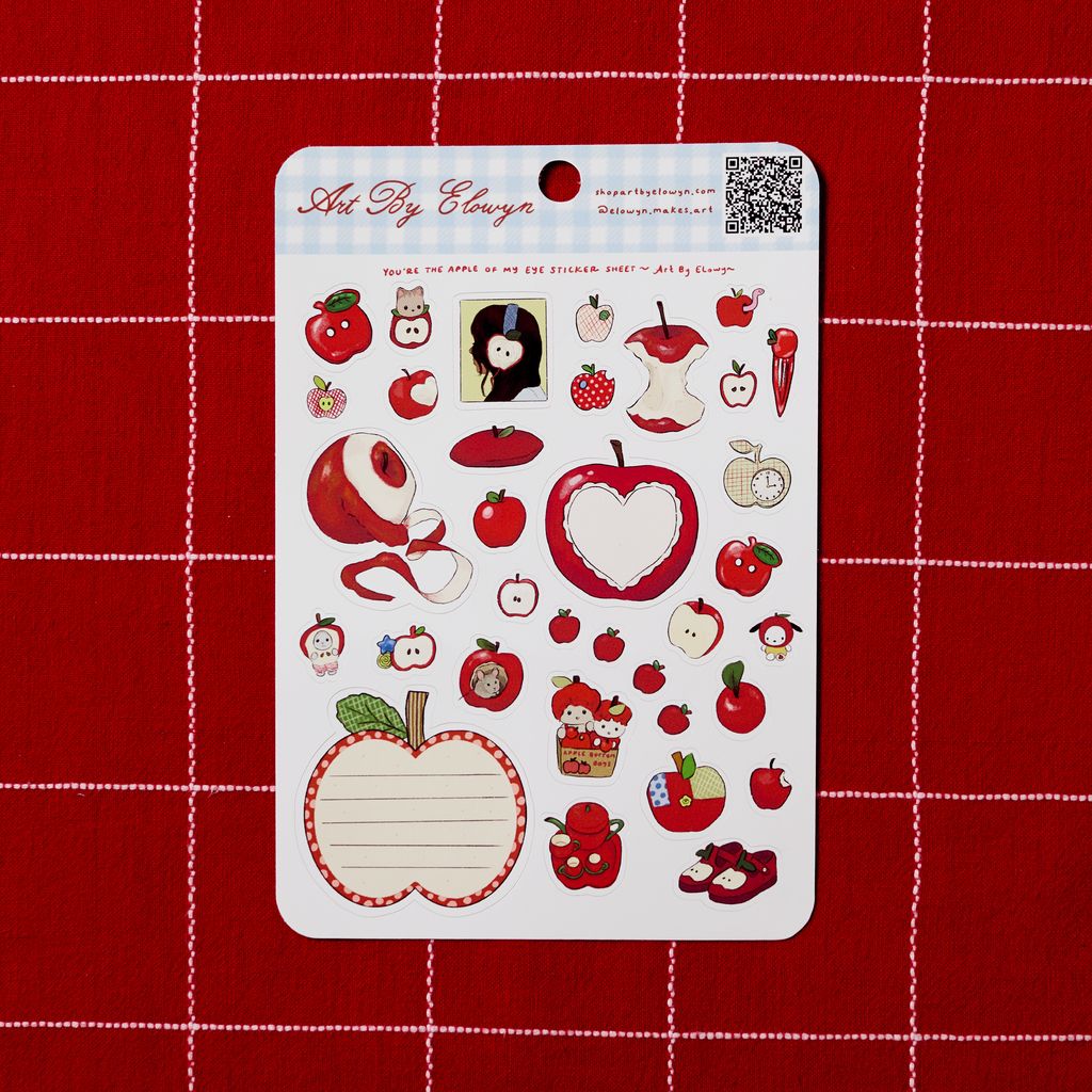 Sheet of apple-themed stickers on a red grid background