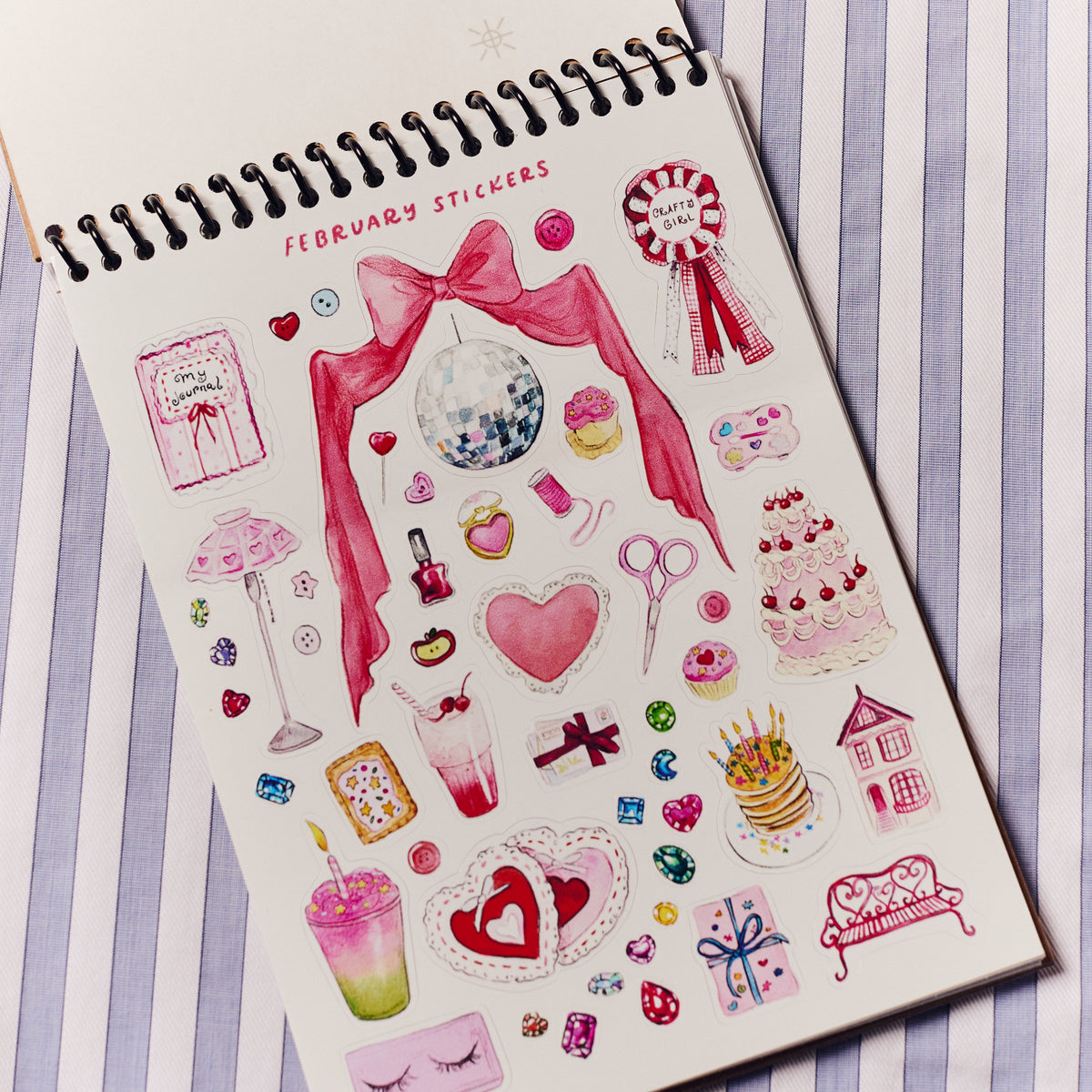 Sheet of February-themed stickers with decorative elements on a notebook