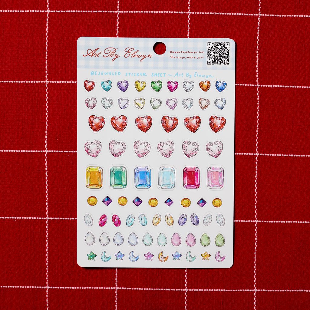 Sheet of gemstone stickers on a red grid background