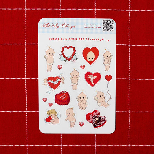 Sheet of stickers with angel babies, hearts, and other designs on a red grid background.