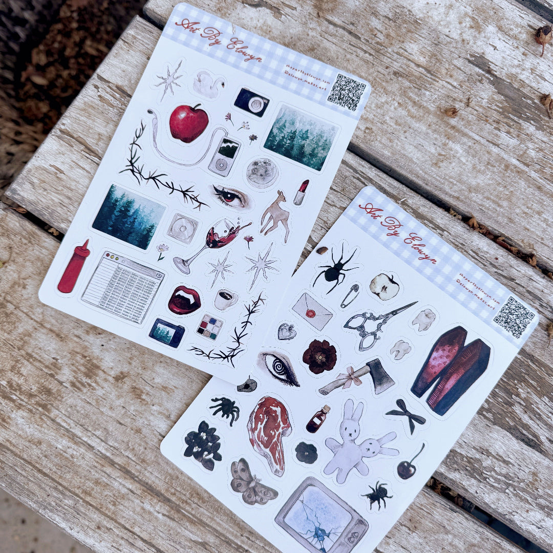 Two sheets of stickers on a wooden bench.
