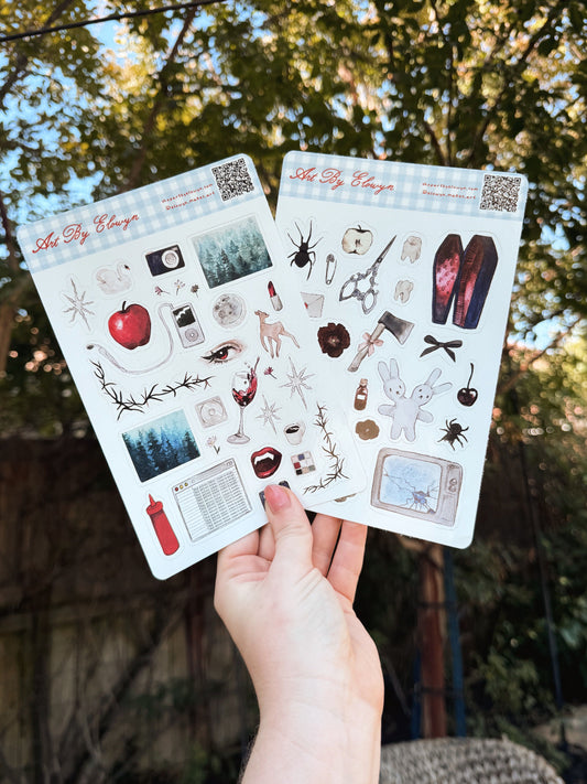A product photo of the two sticker sheet bundle of the Scary Sticker Sheet and The Vampire Sticker Sheet by Art By Elowyn