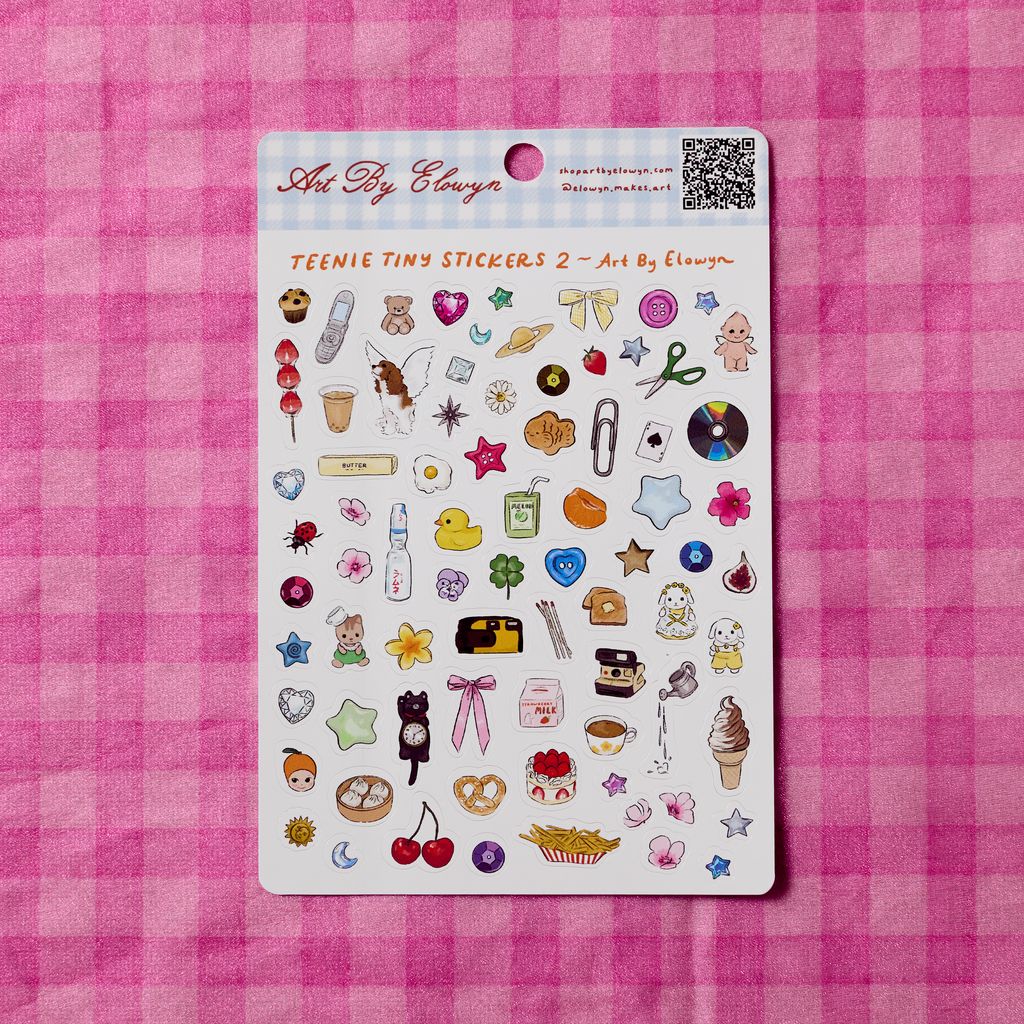 Sticker sheet with various small illustrations on a pink checkered background